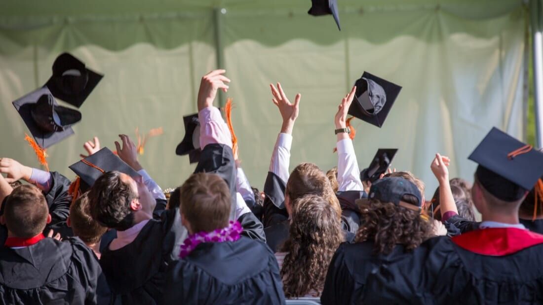 graduates throwing their caps in the air