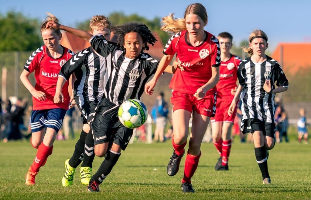 girls play intense game of soccer