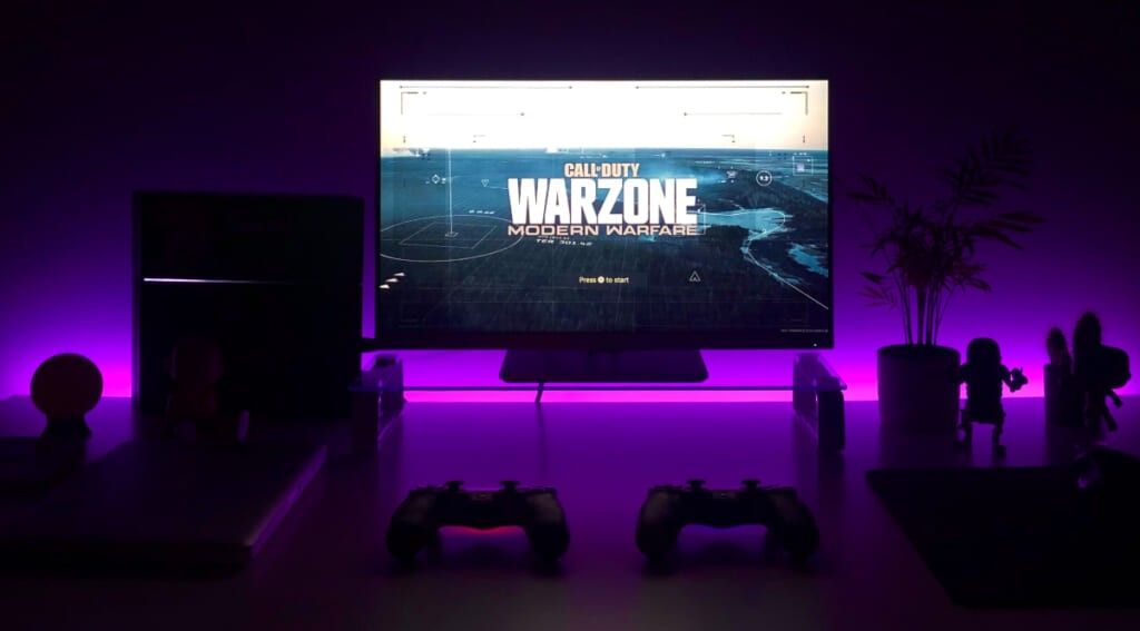 a TV in a dark room with purple lights with 