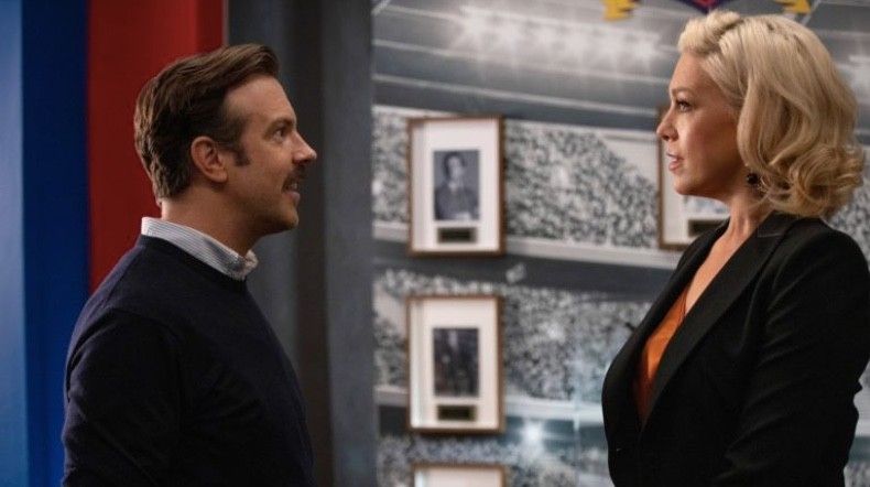 Jason Sudeikis as Ted Lasso and Hannah Waddingham as Rebecca Welton