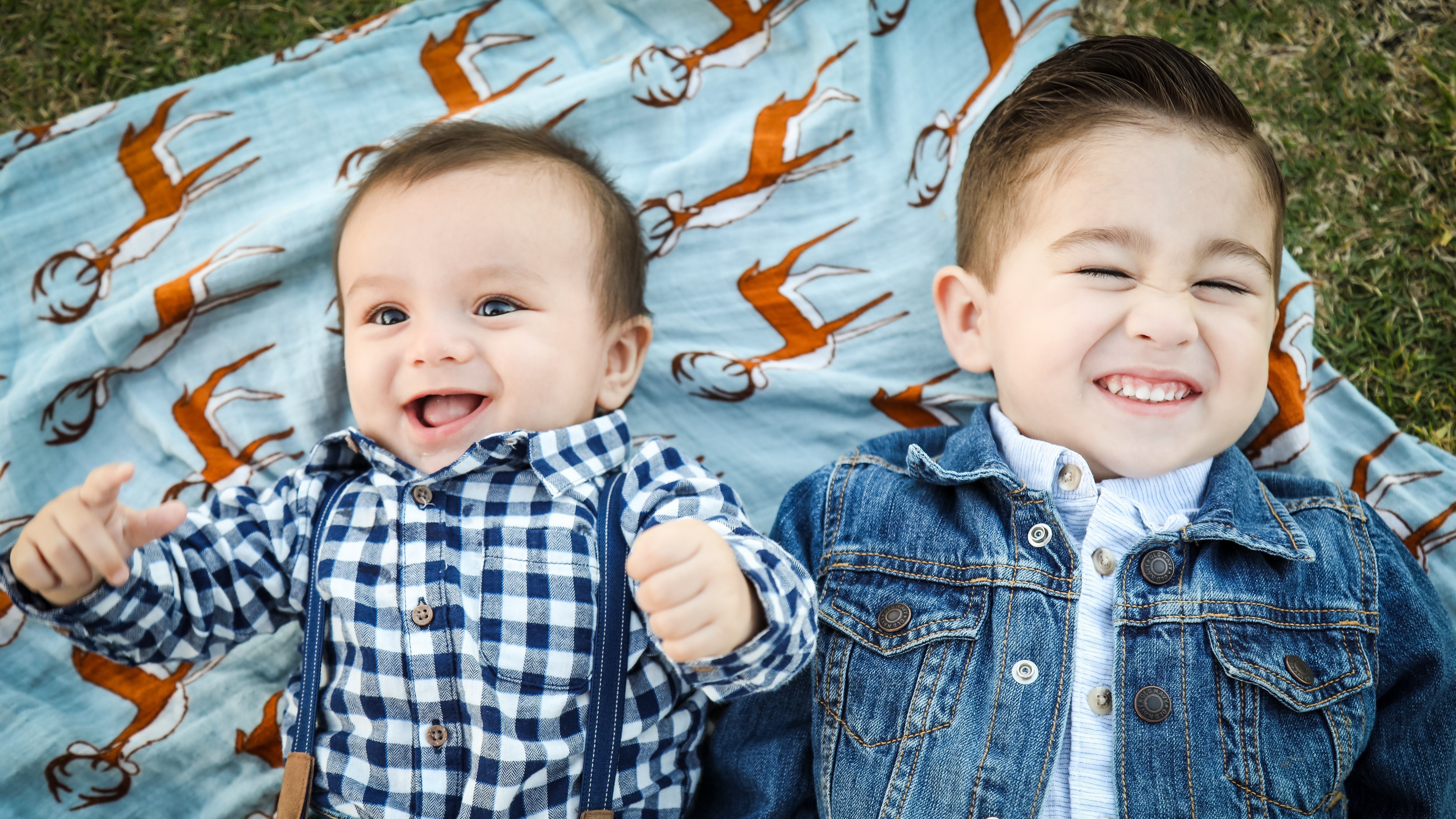 two brothers laying on the ground