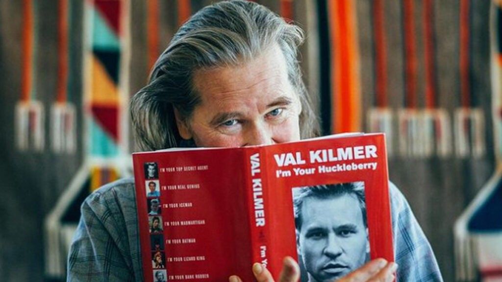Val Kilmer with a copy of his book, I