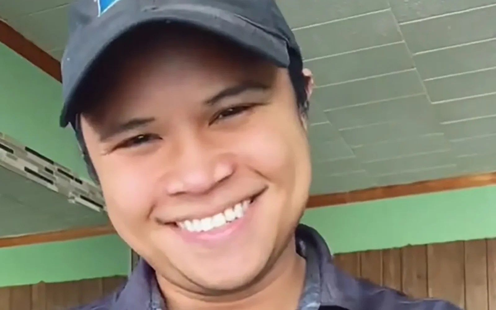 smiling man wearing a cap