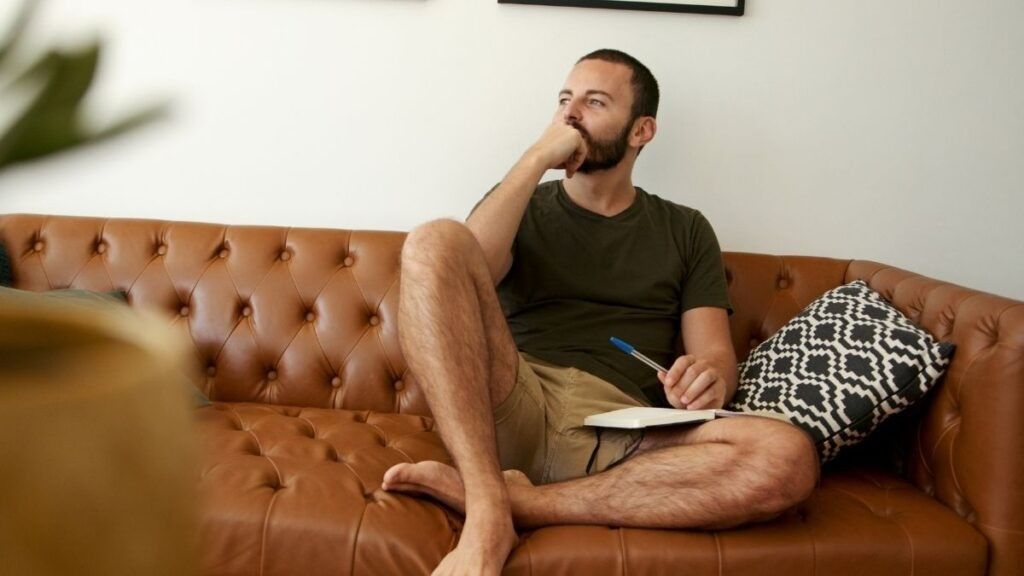 man writing in journal