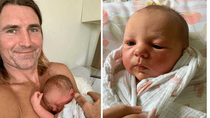 father cuddling newborn daughter