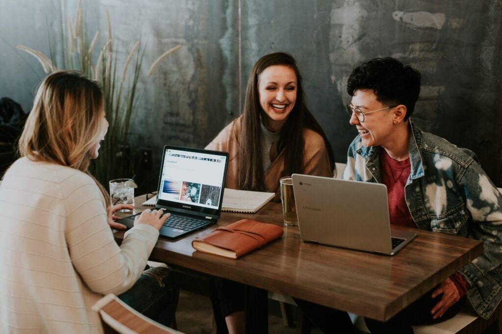 group-people-laughing-using-laptop