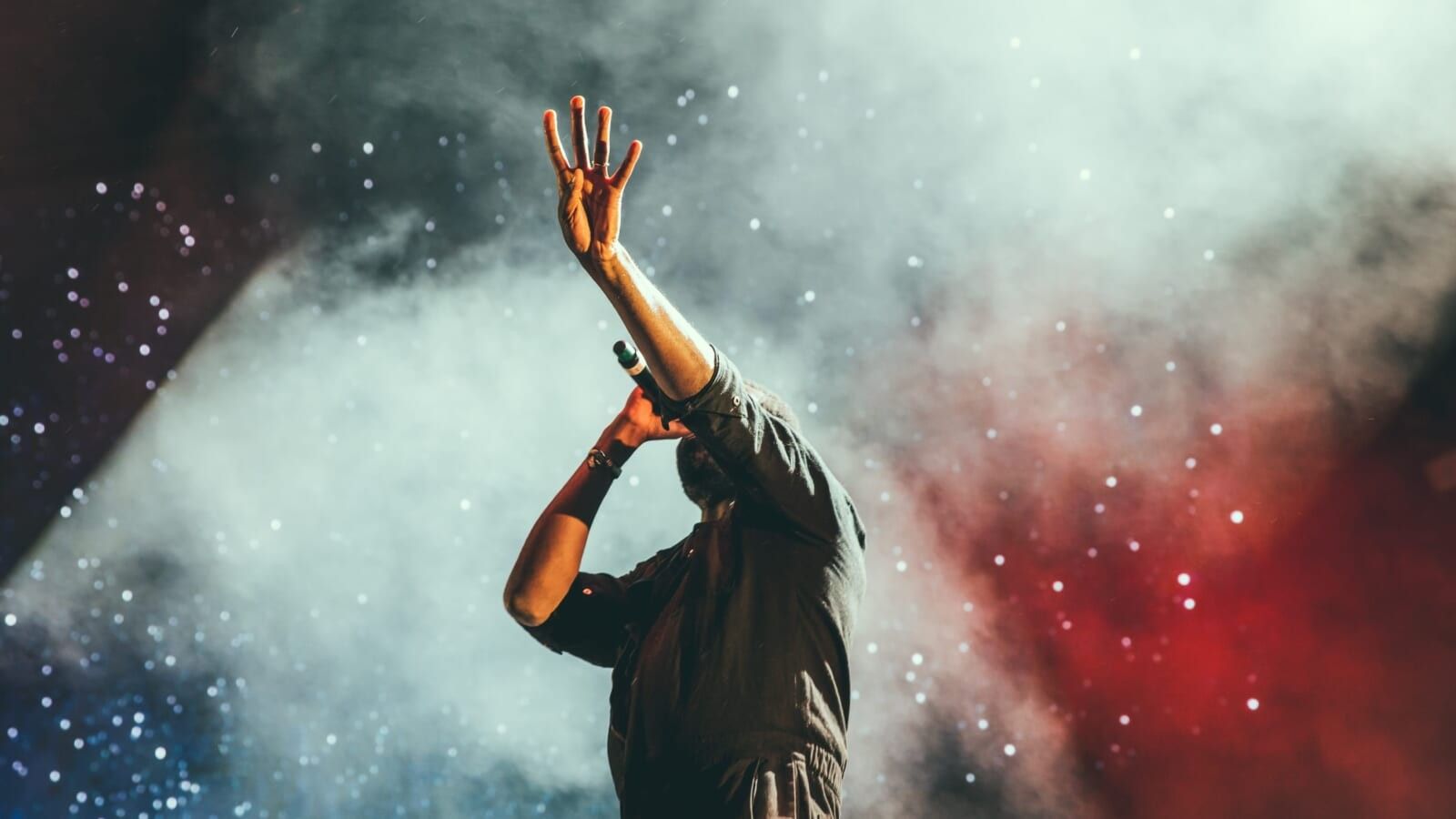 person singing on stage at a concert