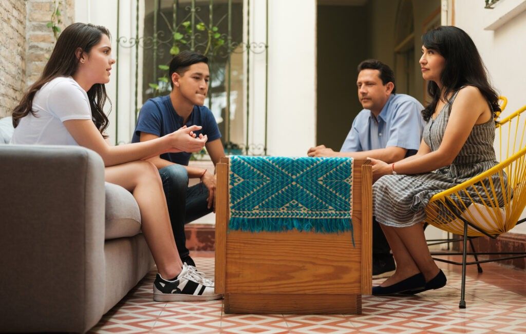 Parents having a discussion with their teenage children