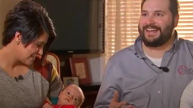 a man and a woman with a baby