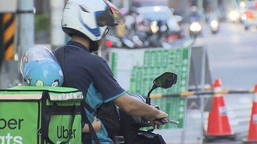 Uber Eats delivery driver with his son on his bike