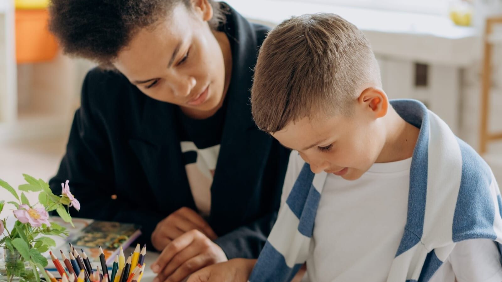 woman teaching little boy