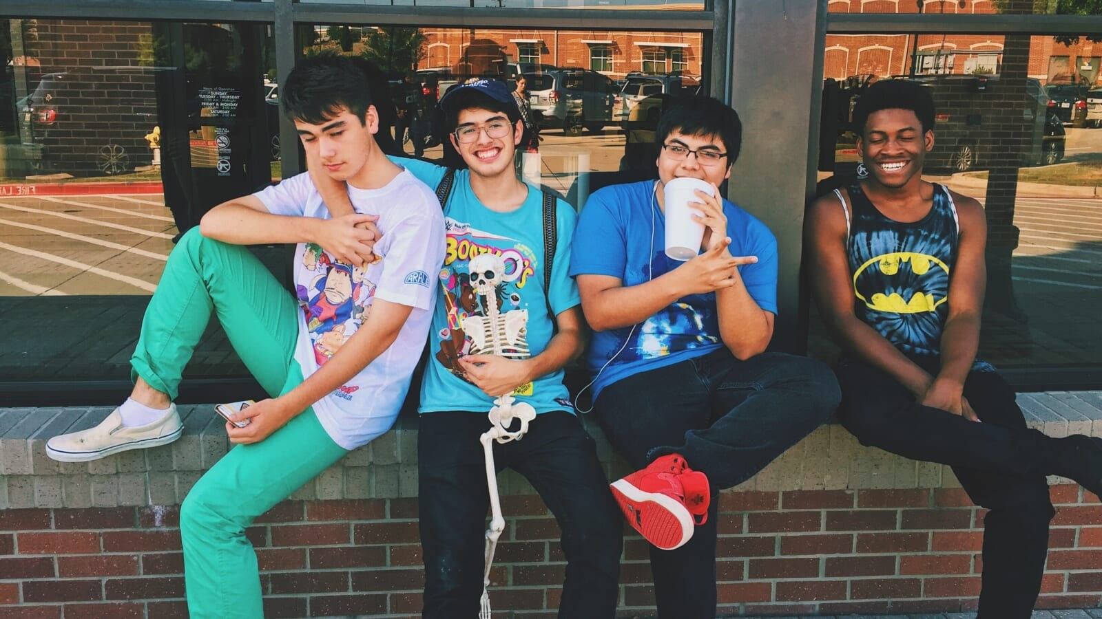 group of buys sitting outside a building