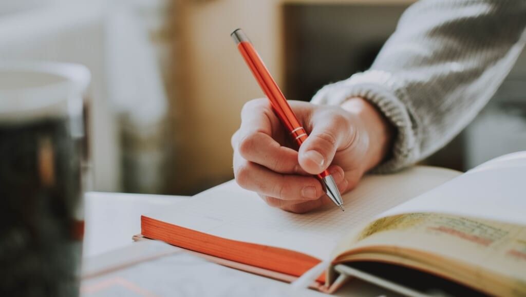 Person writing in notebook