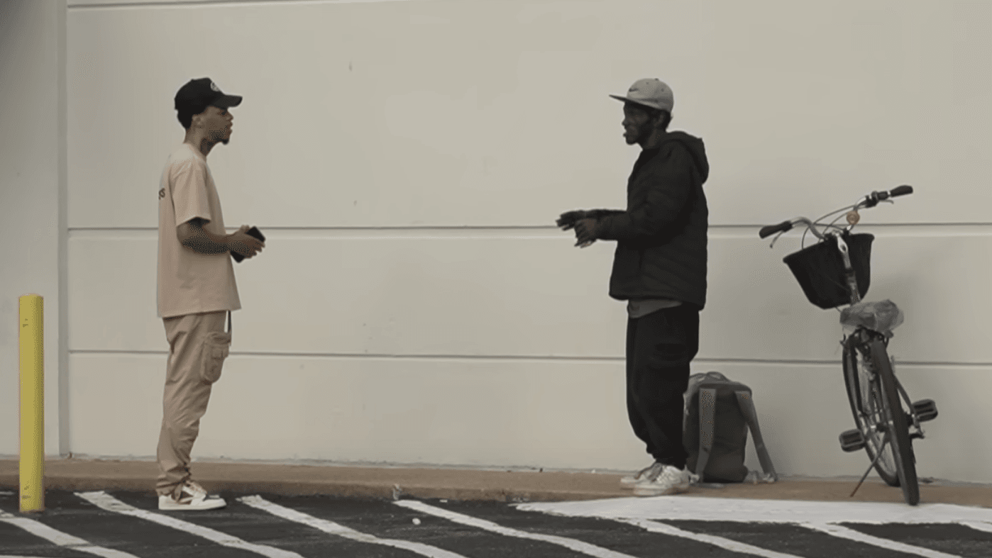 two men talking outside