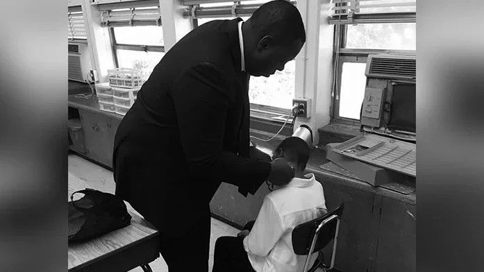 man giving a little boy a haircut