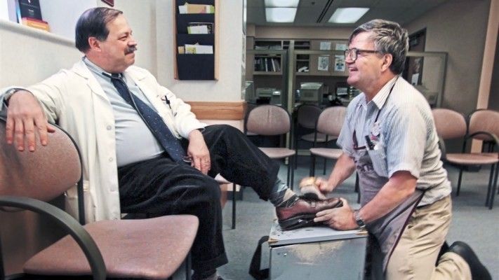 elderly man shining a man