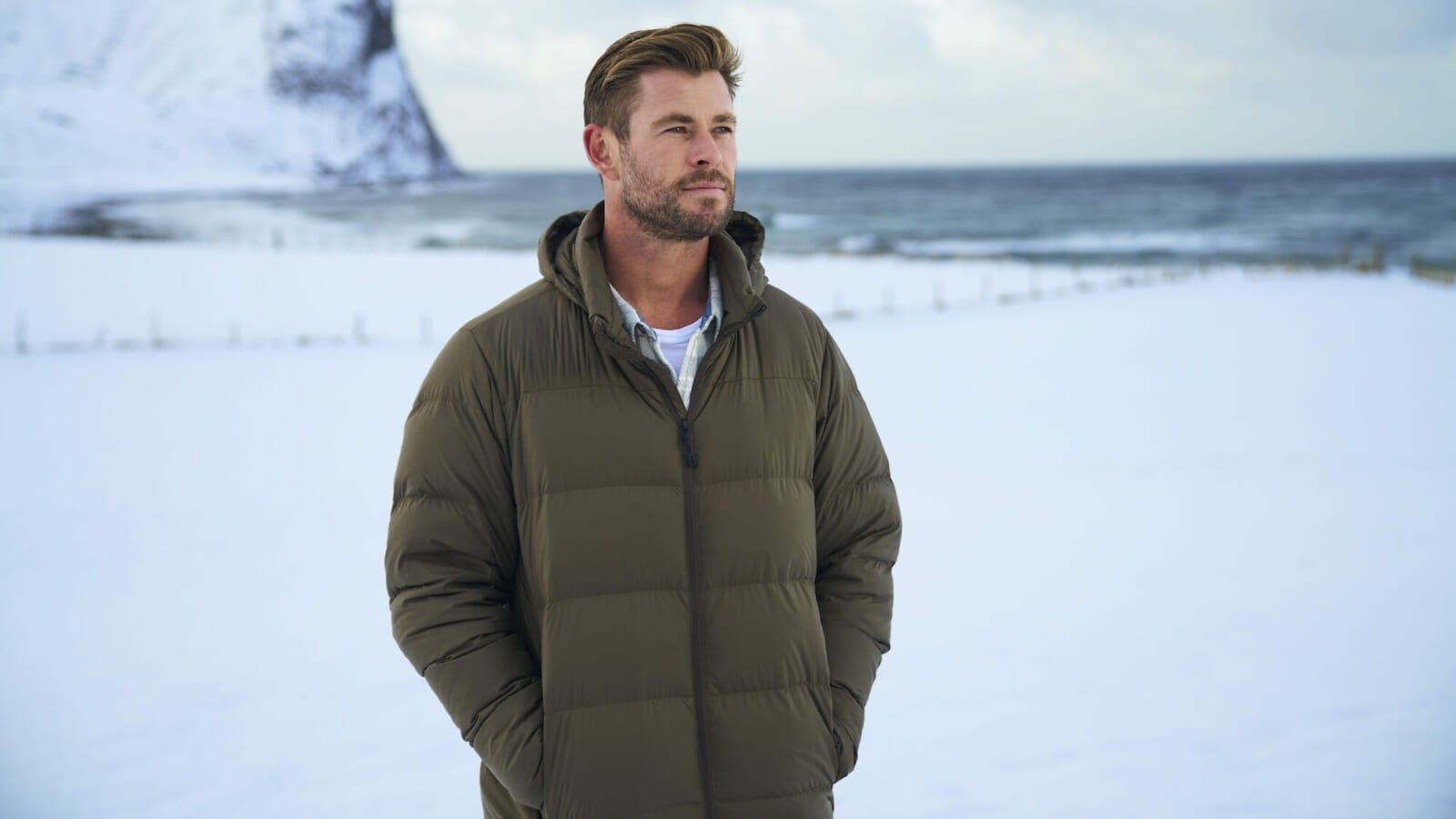 man standing in a jacket in snow