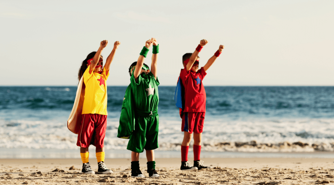 children posing as superheroes