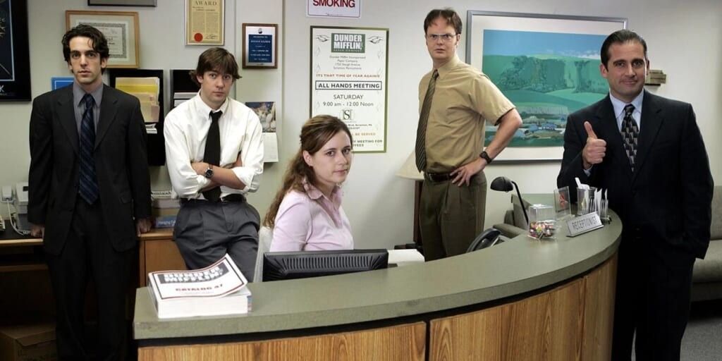 Cast of The Office standing near Pam