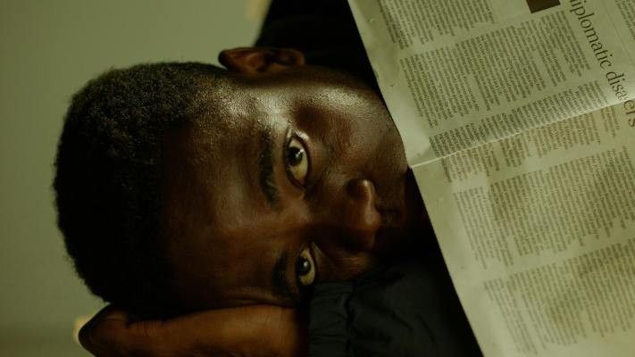man sleeping under newspaper