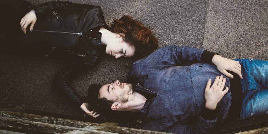 Man and woman lying on floor looking at each other by Toa Heftiba on Unsplash