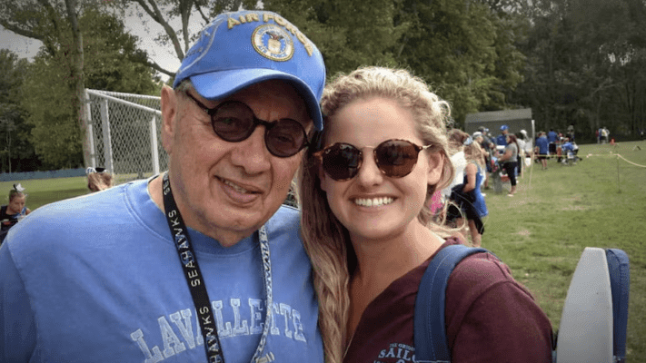 elderly man and his granddaughter wearing sunglasses