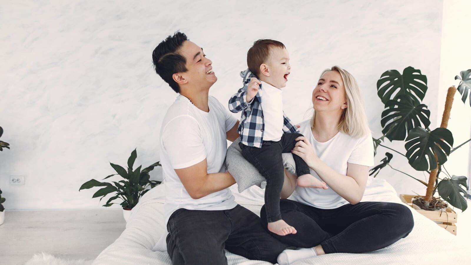 man and woman playing with a little boy