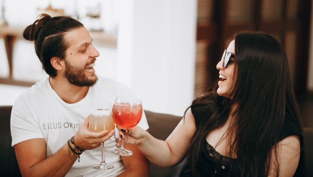 couple flirting with drinks