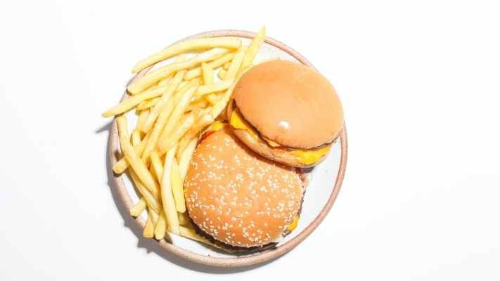 a plate with two burgers and fries
