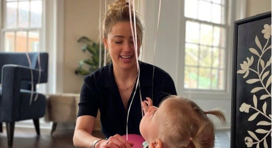 Amber Heard playing with her young daughter. 