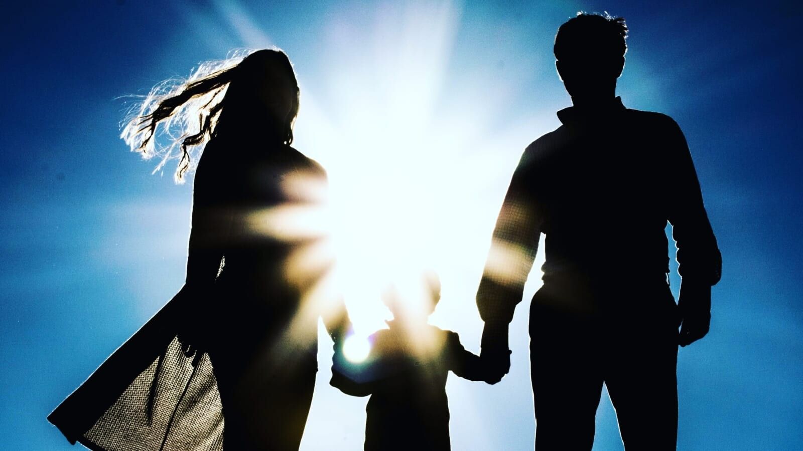 woman and man holding a little child