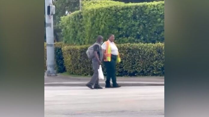 two people crossing the street