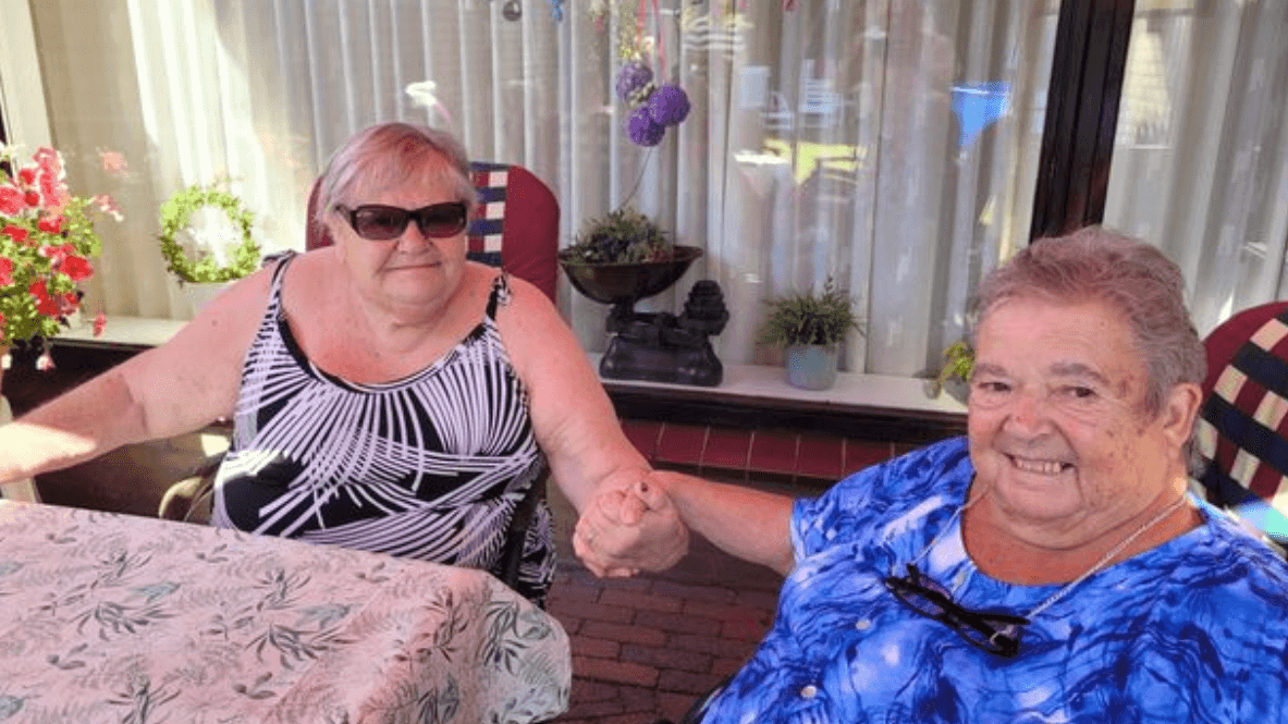 two women holding hands