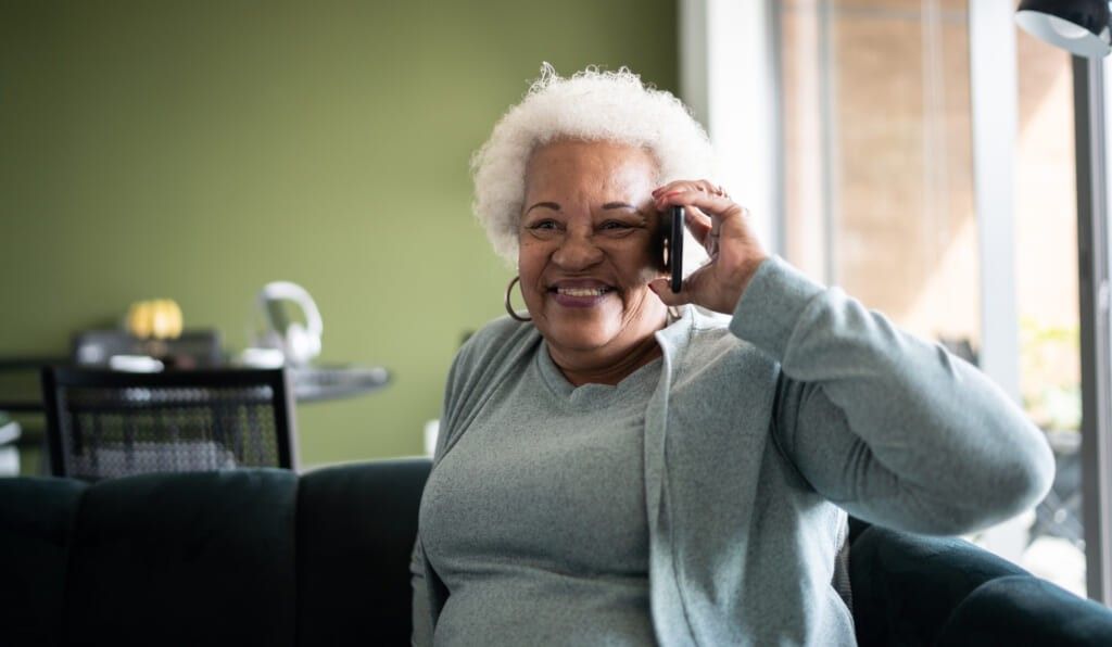 Senior woman talking on the phone at home