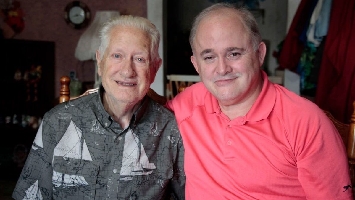 elderly man with a man wearing a neon pink shirt