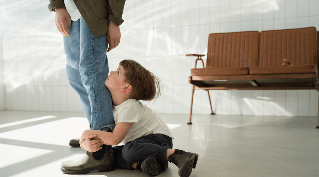 child hugging leg