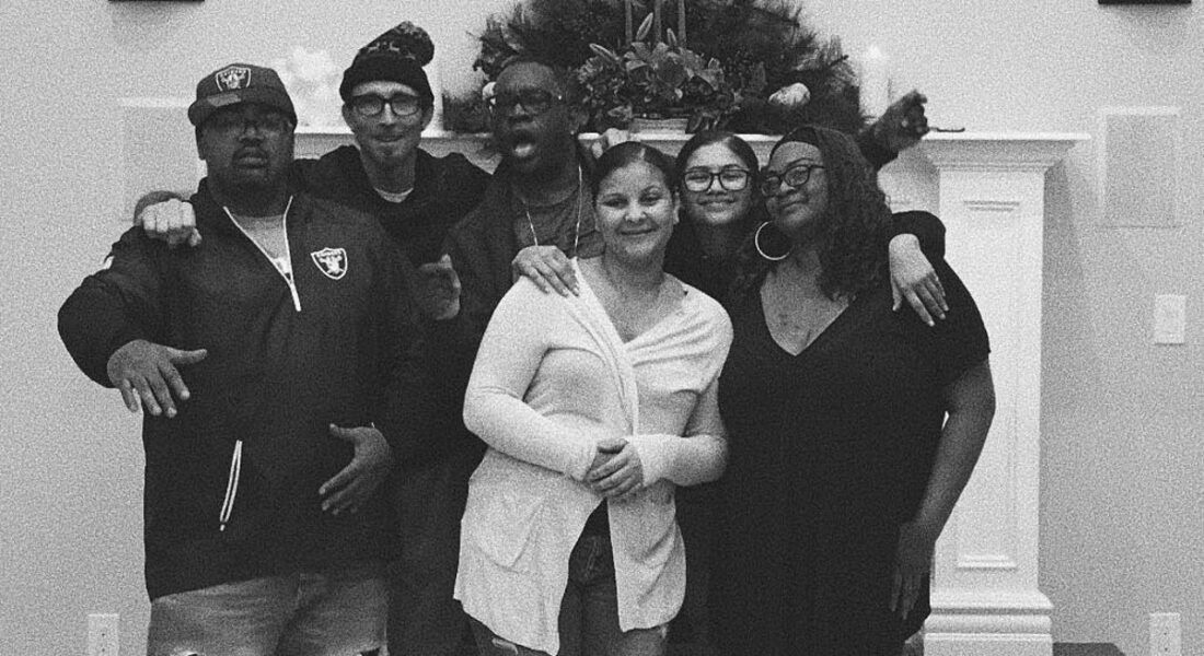 Zendaya posing with her siblings in black and white photo.