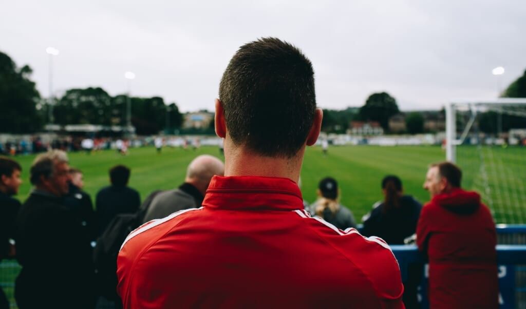 man enjoys soccer game from the stands