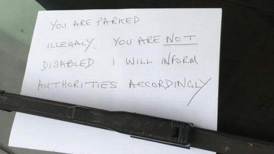 a note placed on a windshield