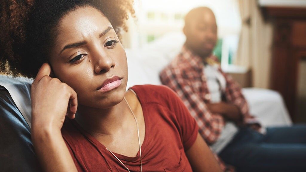 Couple sitting on a couch in a fight