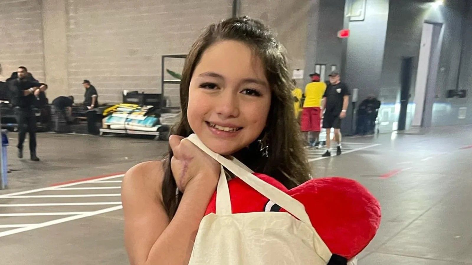 little girl holding a cream color bag