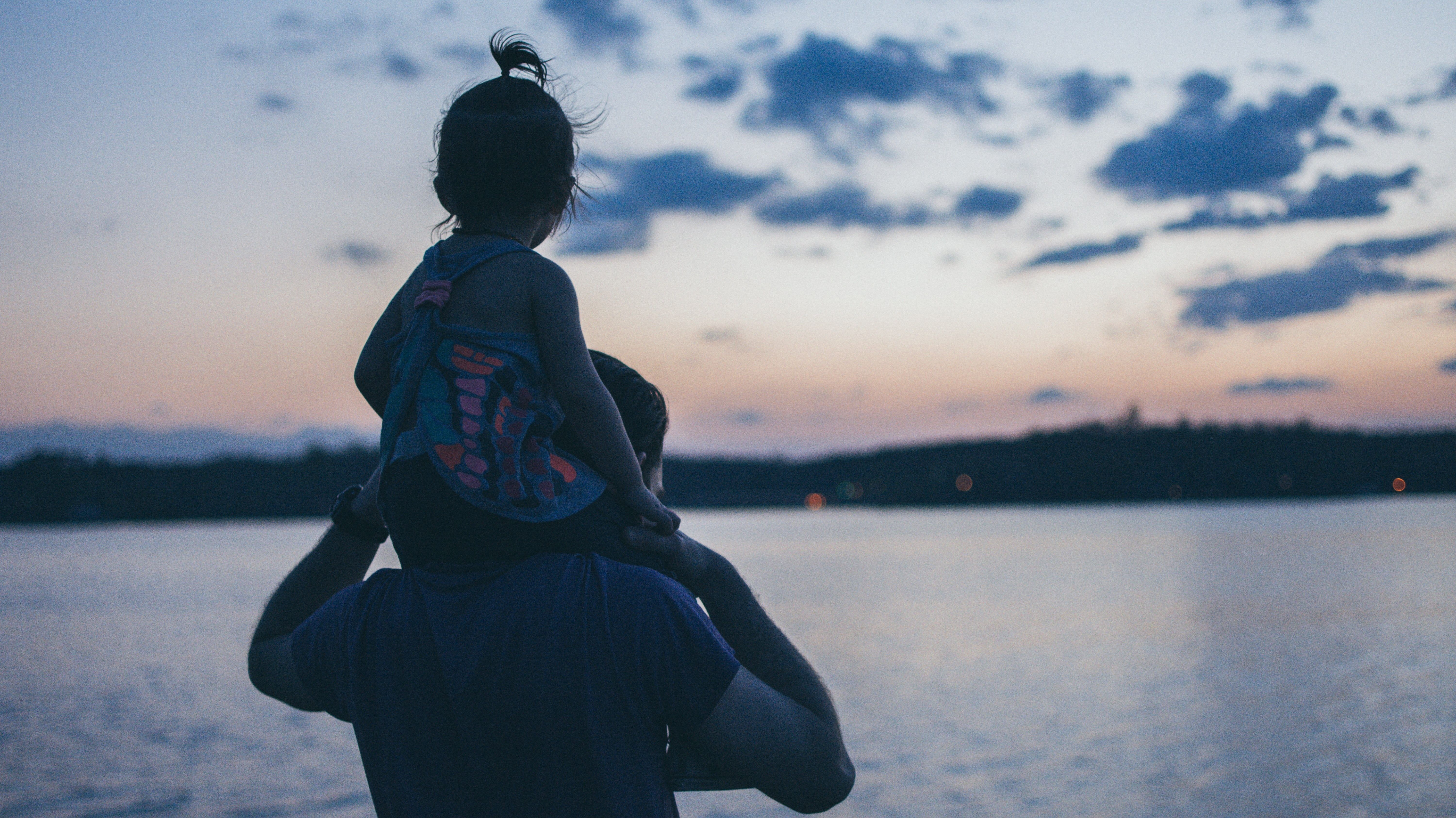 little girl sitting on her dad