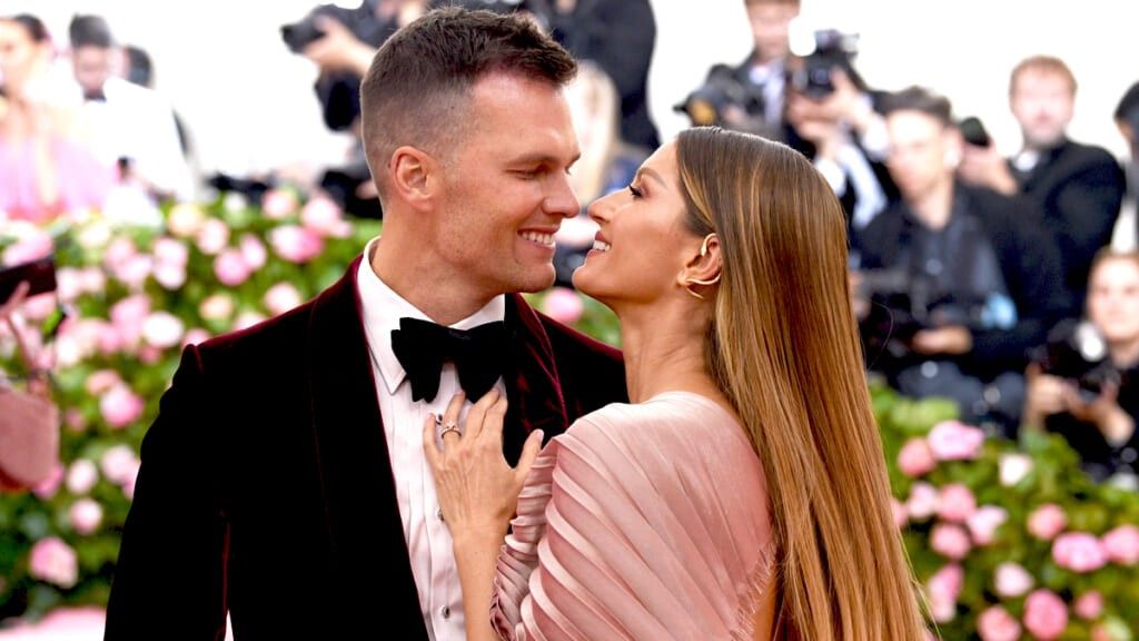 Tom Brady in red velvet with wife Gisele at event