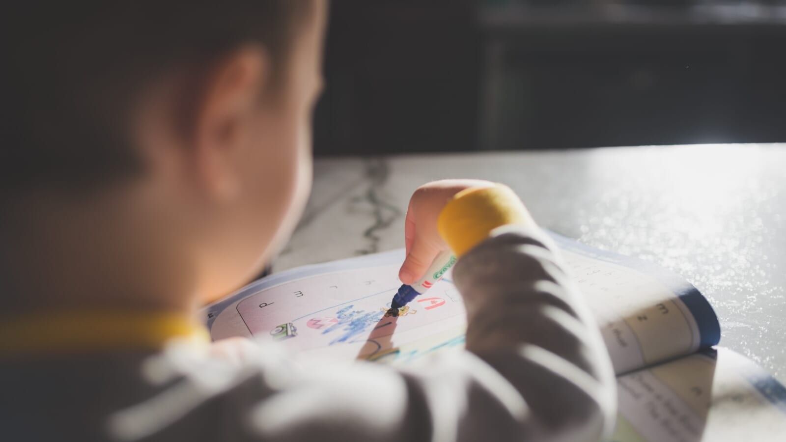 child coloring in a book