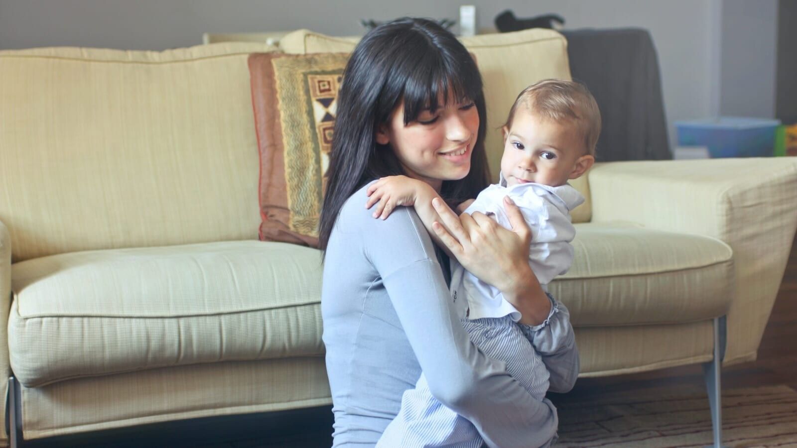 young girl holding a baby
