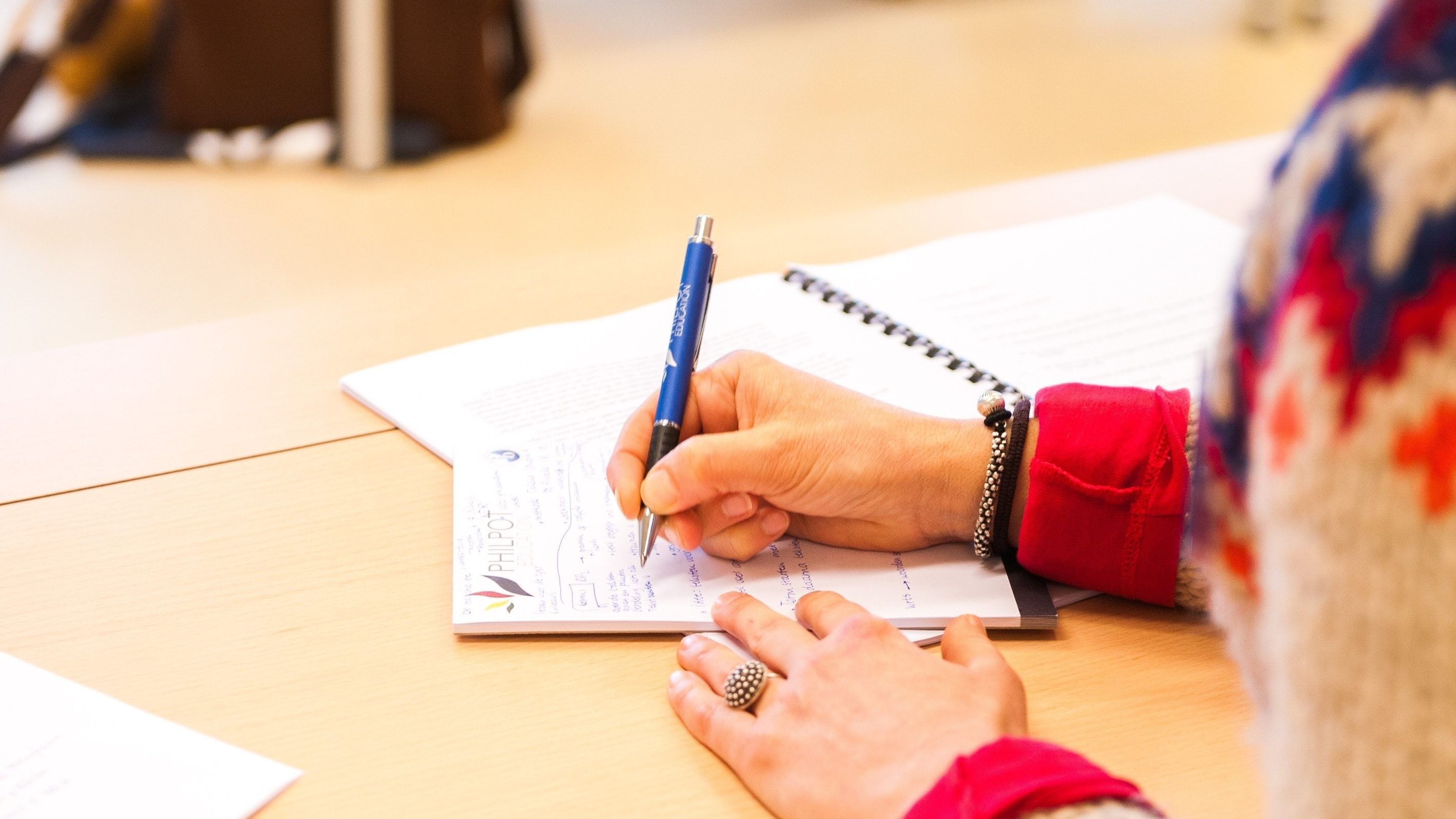 person writing on a piece of paper