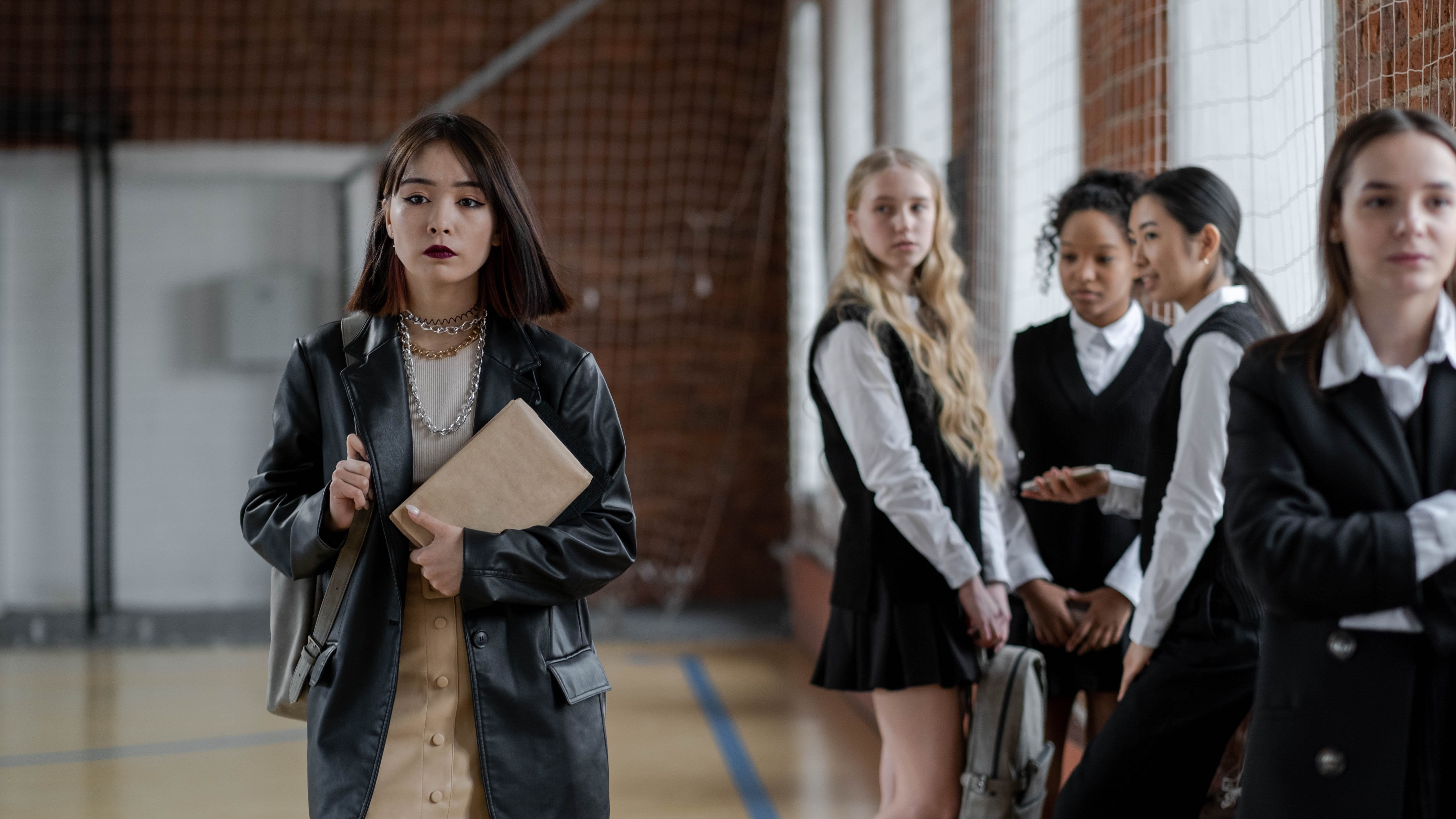 girls looking at their classmate at school