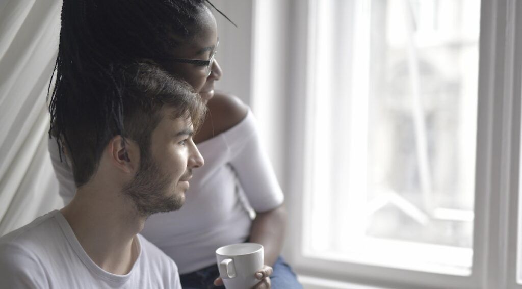 Man in white crew neck t shirt sitting next to a woman in a 3978278 1024x567