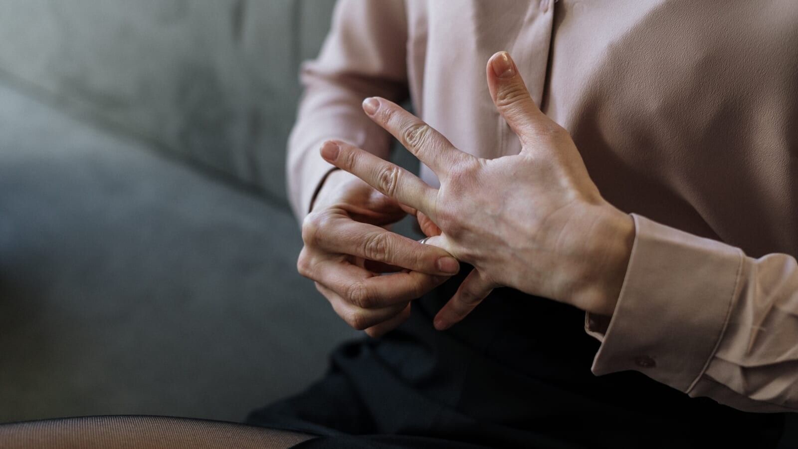 a woman removing a ring from her finger