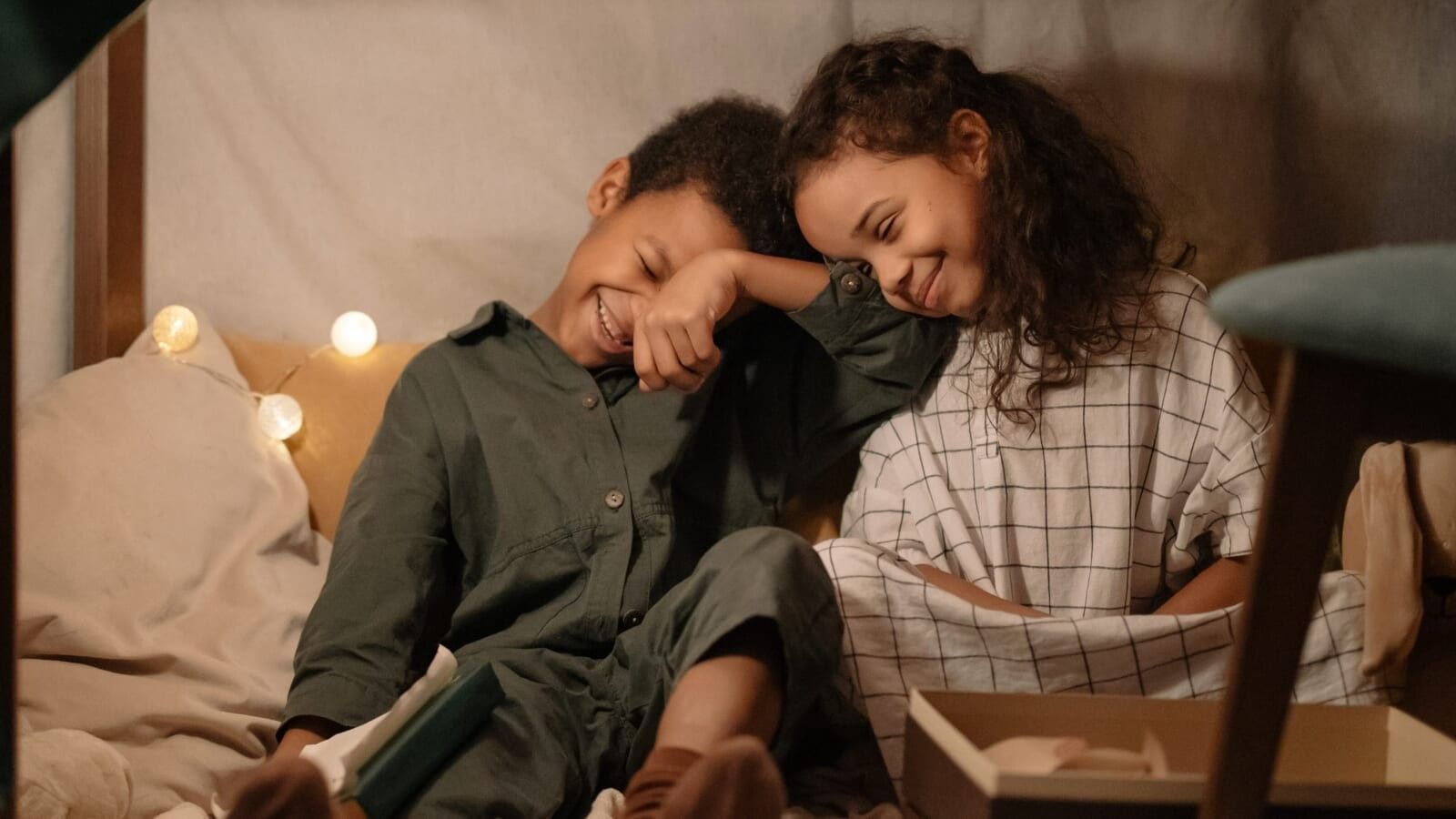 little boy and his sister smiling